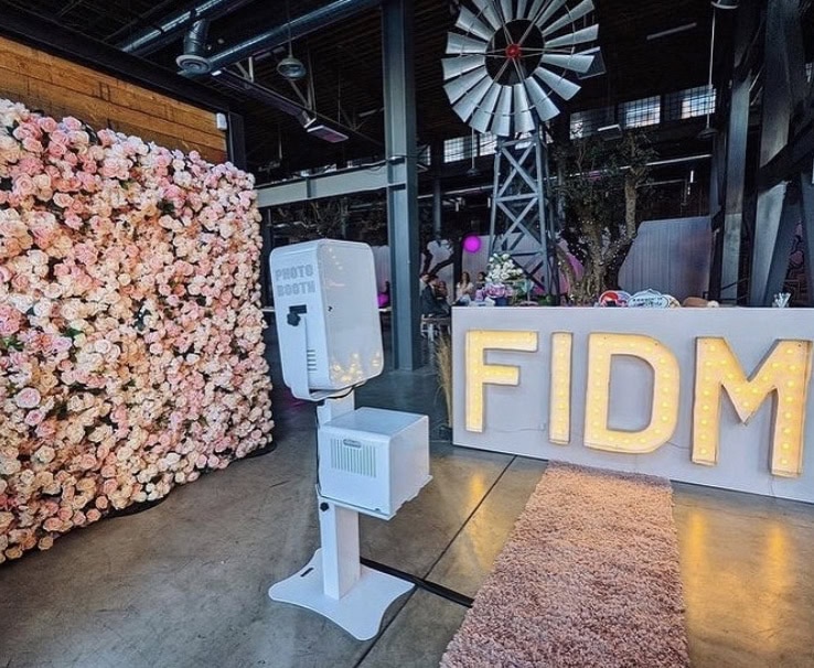 FIDM display with photo booth and flower wall.
