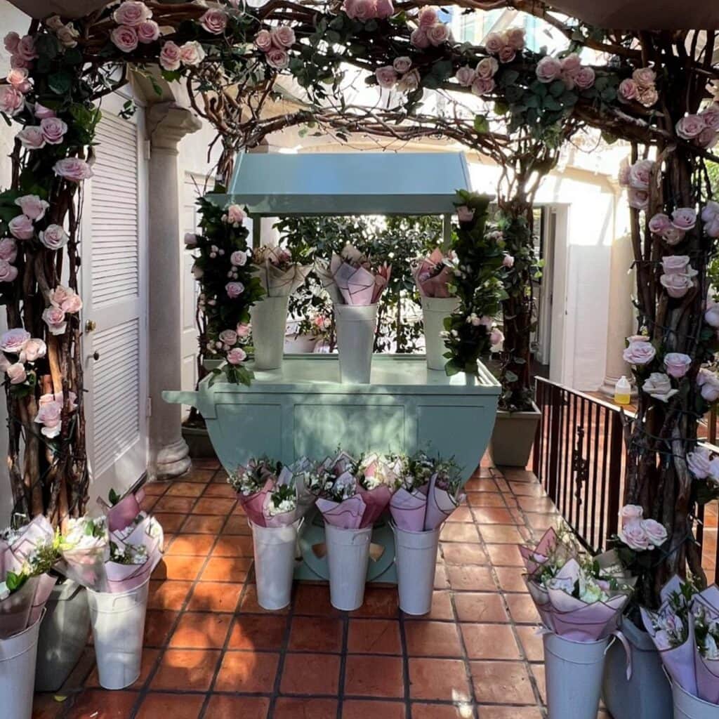 Flower cart with pink roses bouquets