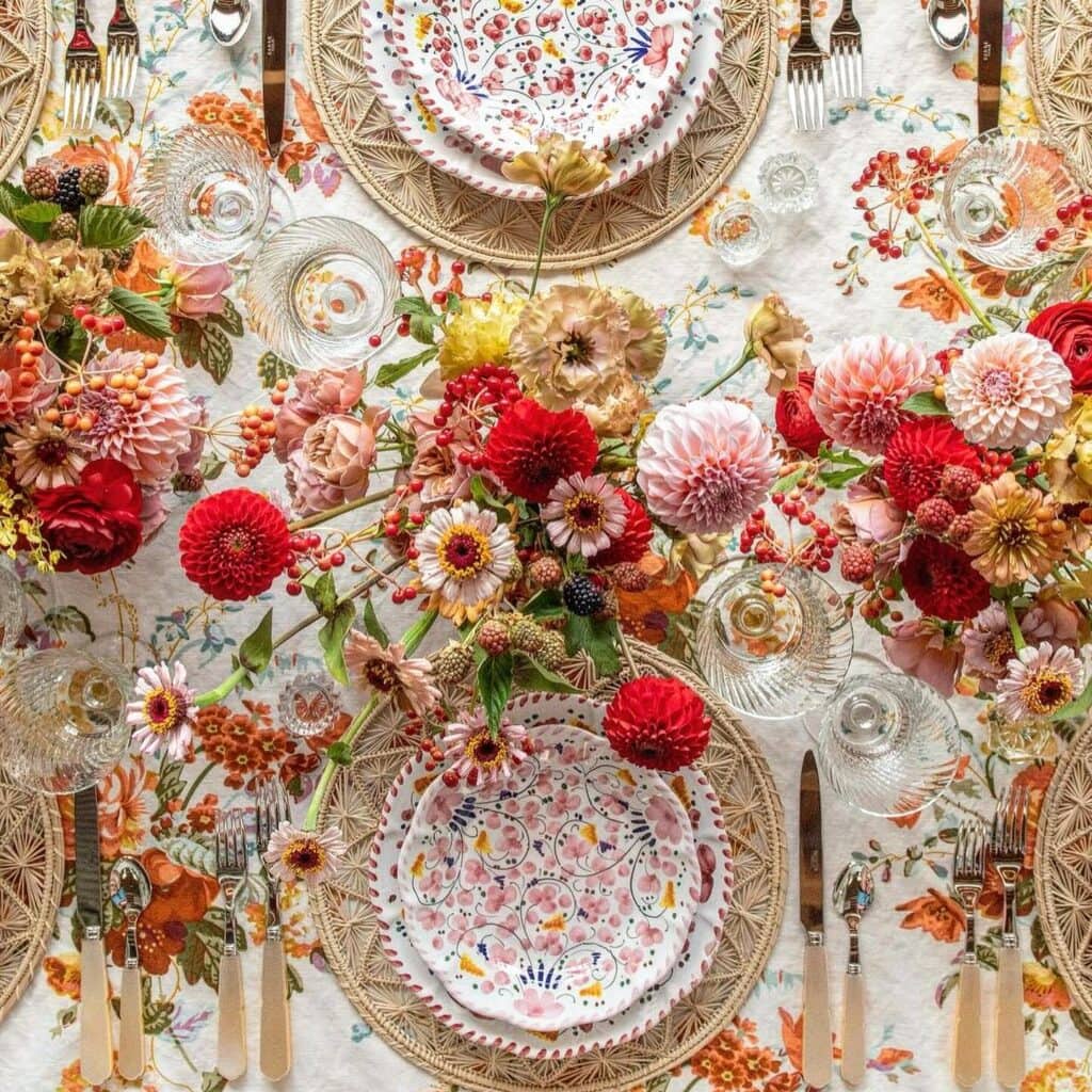 Colorful floral table setting with vibrant flowers.