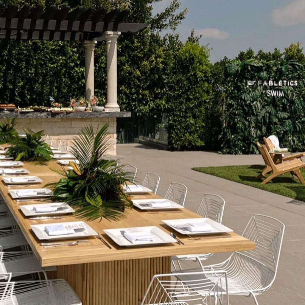 Outdoor dining area with set wooden table and chairs.
