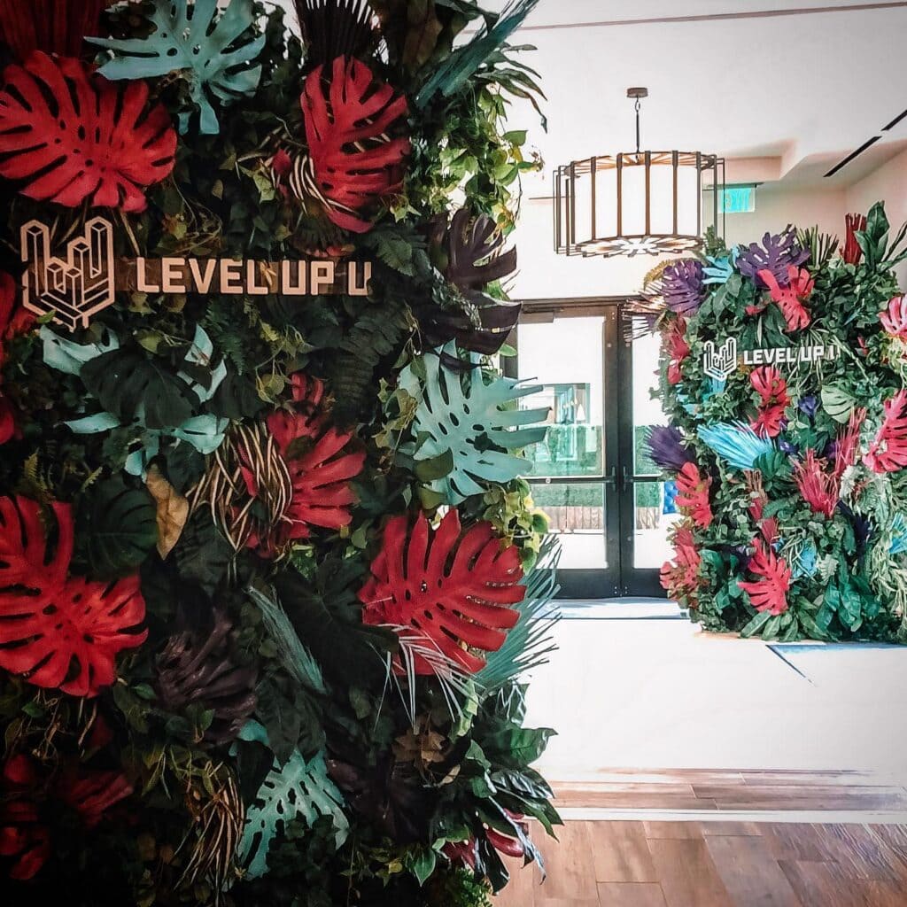 Level Up U event with vibrant leafy decor.