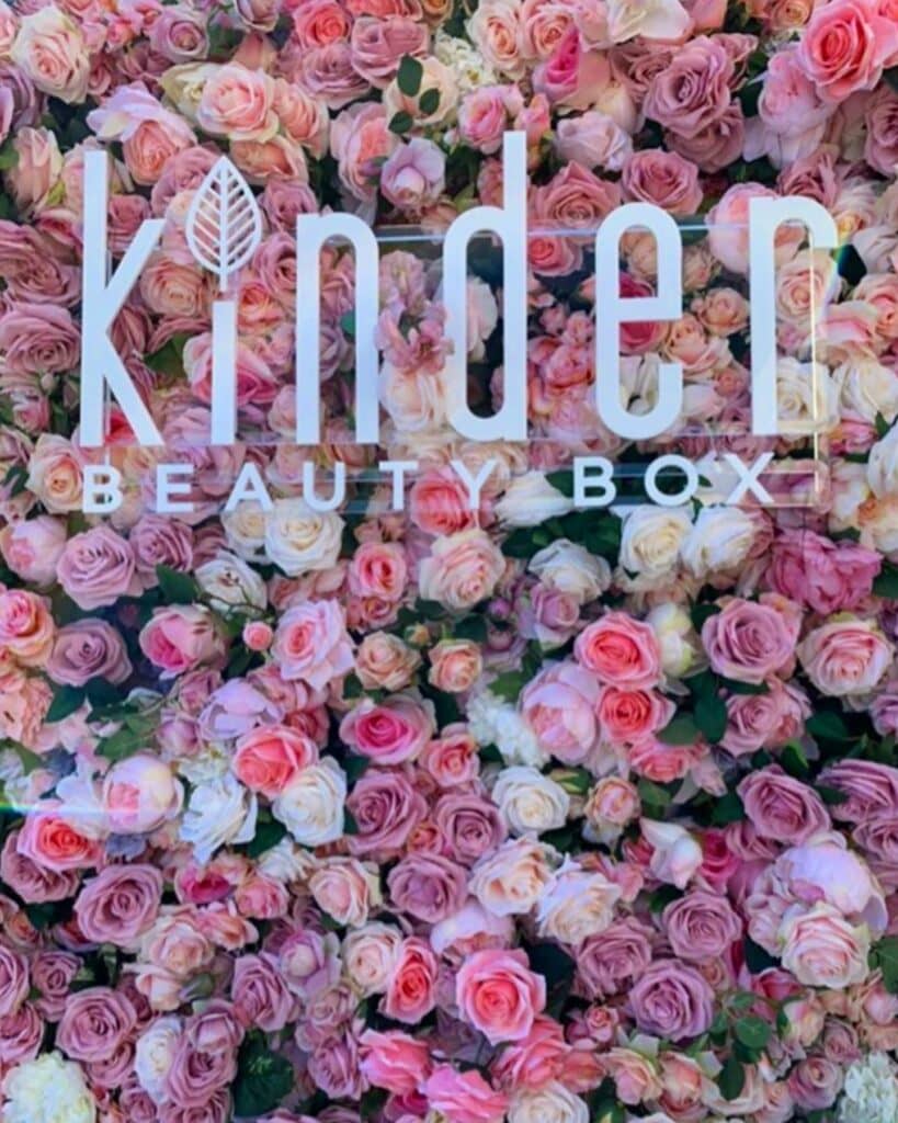 Pink roses background with Kinder Beauty Box logo.