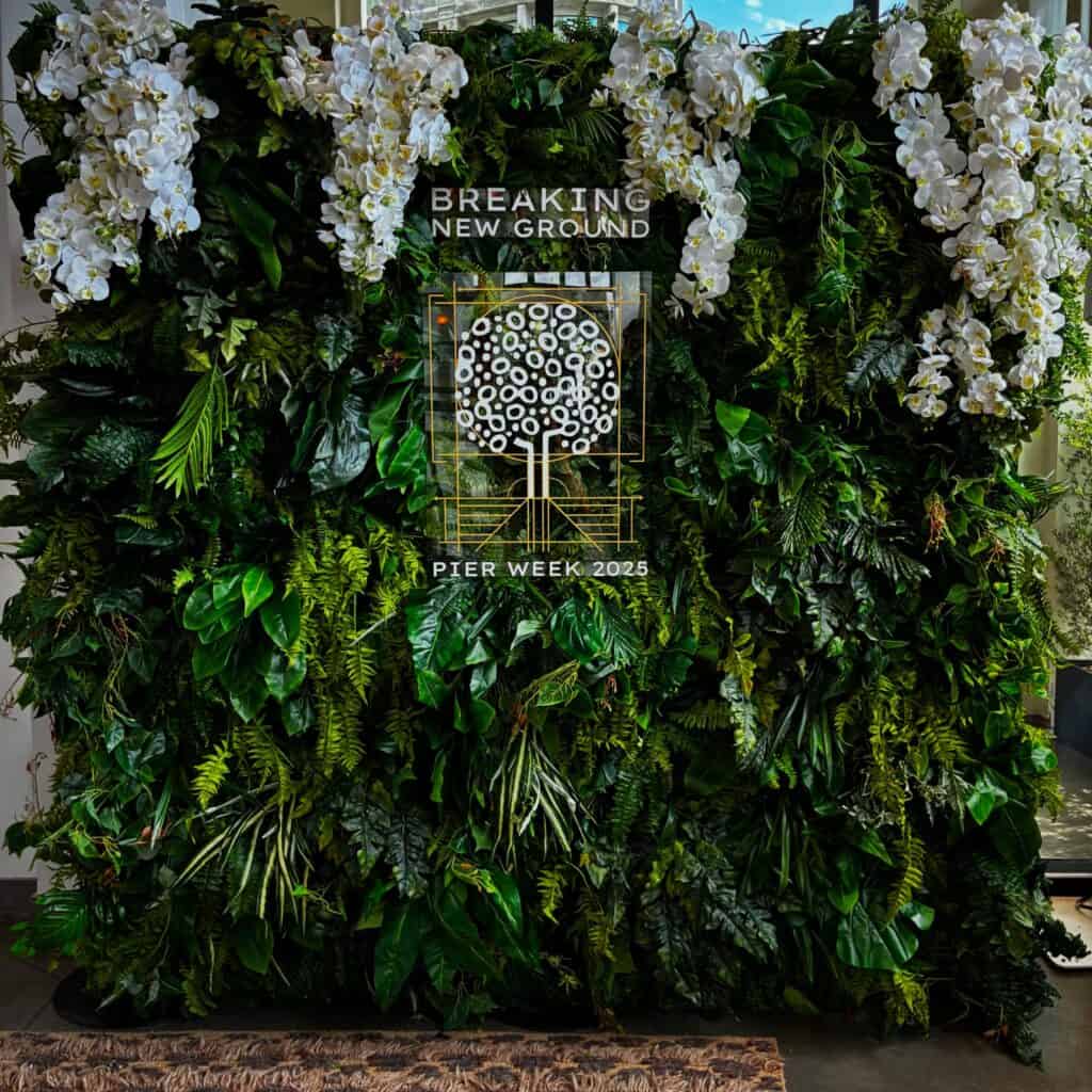 Lush green plant wall with white orchids display